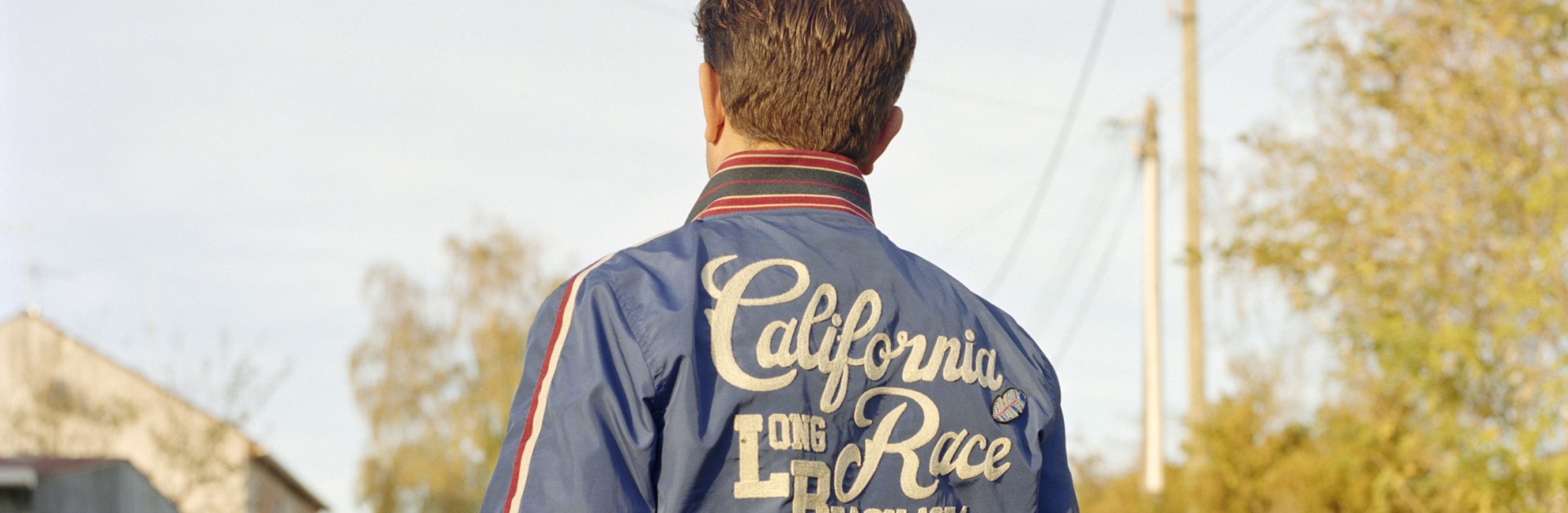 Homme de dos marchant sur une route